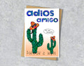 Greeting card with cacti wearing sombreros and 'adios amigo' with personalised text in a speech bubble.