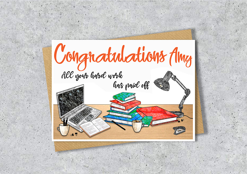 Greeting card with 'Congratulations Amy' text and a illustration of a desk with books, laptop, and lamp.