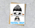 Greeting card with a cartoon character wearing a black and white striped hat, text 'Favourite team Christopher' and 'FOOTBALL CRAZY' 