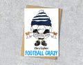 Greeting card with a cartoon character wearing a navy and white striped hat, text 'Favourite team Christopher' and 'FOOTBALL CRAZY' 
