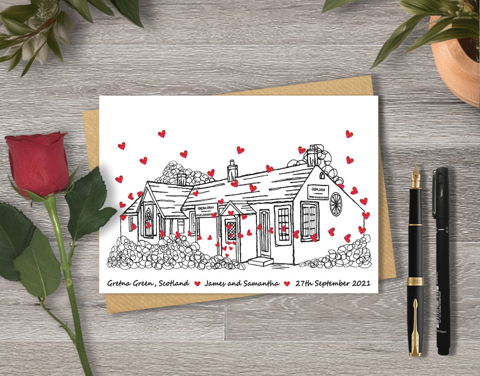 Wedding / Anniversary card with a black and white textile illustration of gretna Green and red hearts with personalised text.