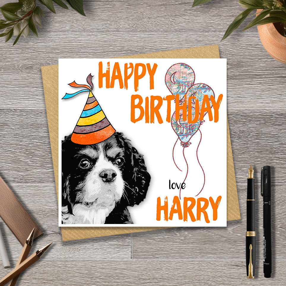 Birthday card with a King Charles Spaniel wearing a party hat and balloons, with personalised text.