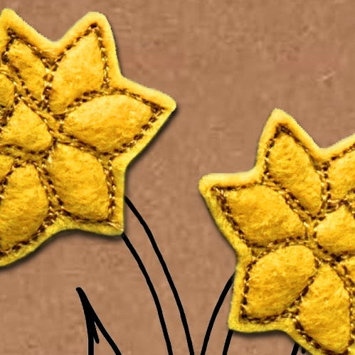 Two yellow flowers on a brown background with 'Happy St David's Day' text.